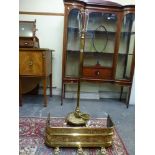 An early 20th century brass standard lamp with telescopic column on claw feet, together with a