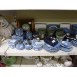 A shelf of mainly Wedgwood green and blue Jasperware china comprising plates, vases, candlesticks,