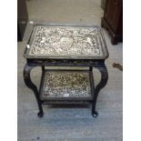 A pretty Eastern occasional table in black lacquer the top and lower shelf profusely inlaid with