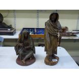 A pair of Italian 19th century papier maché figures of Arabs: a seated woman and a standing man, man