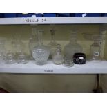 A shelf of glass ware including a 19th century etched glass comport, a ring necked decanter and