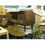 A 1960s dining room suite by G-Plan comprising a small sideboard in teak with one black fronted