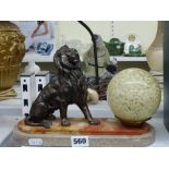 A vintage novelty table lamp, in the form of a bronzed spelter lion seated by a mottled glass
