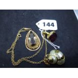 A pendant set with a smoky quartz, tests as 14 ct gold; a 9 ct gold reproduction fob seal with