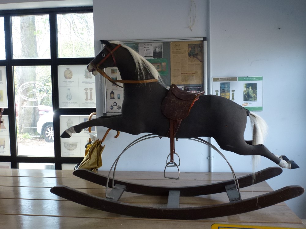 A 19th century and later 'Galloper' rocking horse,  black fabric over wood and stuffed body on