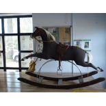 A 19th century and later 'Galloper' rocking horse,  black fabric over wood and stuffed body on