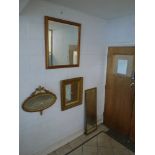 Four gilt framed mirrors including an oval mirror with urn and flower decoration and a long dressing