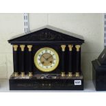 An attractive late 19th century French mantel clock of temple form, in slate, marble and gilt metal,