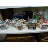 A collection of teapots including the Bovey Pottery Company teapot of The Rovers Return, seven