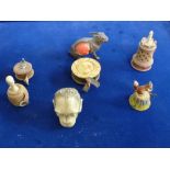 A good collection of seven vintage and antique tape measures, including a squirrel in painted metal,