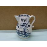 An 18th century Lowestoft blue and white porcelain sparrow beak milk jug, painted with leafy and
