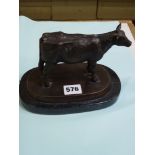 A bronze figure of a cow on dark base, 19.3 cm long overall [D] WE DO NOT ACCEPT CREDIT CARDS.