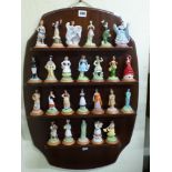 A set of 28 Banbury Mint Lovely Ladies from Many Lands set of figurines on mahogany hanging wall