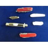 A collection of six penknives, including a Swiss army multi-use example, a small antique horn-