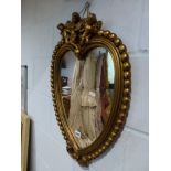 A gilt framed heart shaped mirror with cherub surmount. WE DO NOT ACCEPT CREDIT CARDS. CLEARANCE