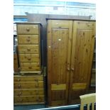 A modern pine hanging wardrobe and three matching chests of drawers of various sizes, a dressing