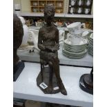 A Polish heavy bronze figure of a seated woman reading, signed Ihnatowicz 64, 31 cm high [D] WE DO