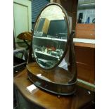 A stylish mahogany dressing table mirror the large bevelled and oval plate between cabriole supports