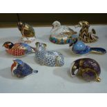 A collection of eight Royal Crown Derby paperweights, all with gilt stoppers, comprising: a swan,
