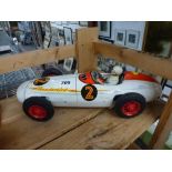 A good Mettoy tin-plate clockwork model of a vintage racing car with plastic driver, finished in red