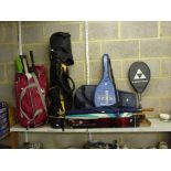 A quantity of sporting items including tennis rackets, golf clubs, golfing umbrellas, spring