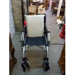 A Breezy Folding Wheelchair with pressure point seat and footrests. WE DO NOT ACCEPT CREDIT CARDS.