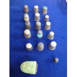 A collection of 17 vintage and antique thimbles, mainly in silver, including one with enamelled