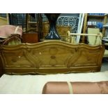 A spectacular Italian bedstead, in shaped and carved polished wood, 70 in wide approximately. WE