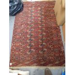 A finely woven old Turkoman rug with two rows of guls on a wine field, and a small modern Eastern