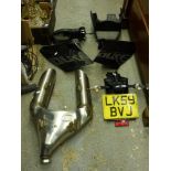 An unused high performance twin exhaust motorbike in stainless steel, possibly for a KTMLC8V twin