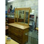 An Italian three-drawer dressing chest, circa 1900, with triple mirror back within a carved frame,