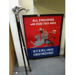 A large framed Sterling Destroyed mirror/sign depicting a griffin and two modern walking canes