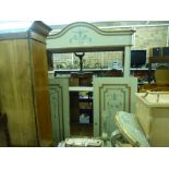 A handsome 19th century Italian wardrobe, painted in pale green, with domed cornice and panelled