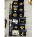 A collection of 12 porcelain bonbonnieres that includes a Homeward Bound pill box, a Ltd Ed oval
