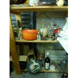 Two shelves containing a miscellaneous collection of household items and ornaments that includes,