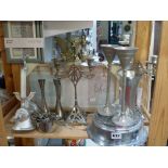 A metalware lot including a German wall barometer, a pair of two-branch candlesticks, a mincer,