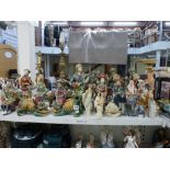 A large collection of Oriental pottery figurines of seated ladies, ladies playing violins, etc., men