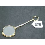 An antique Continental gold lorgnette, tests as 9 ct, inset with tiny rubies and blue enamel, 21.3