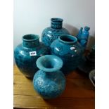 Four turquoise-glazed pottery vases, variously painted in black, comprising: a Multan example with