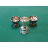 A late Victorian sturdy silver capstan pepper mill, London 1889; and a pair of egg cups from a
