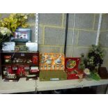 A display shelf containing miniature coca cola memorabilia, glass and stone grapes, a Japanese
