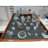A collection of small Swarovski crystal figures, several with coloured detail, approximately 27 in