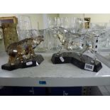 Two impressive Swarovski silver crystal figures, of a bull and of a bear, each on stone base, 16