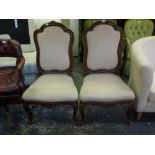 A pair of 18th century Continental side chairs of pretty outline, the moulded chestnut frames
