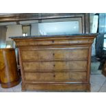 A French Restoration period commode veneered in figured ash comprising four long drawers beneath a