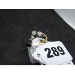 A diamond crossover ring, in 18 ct yellow gold with white metal claw settings to the two stones,