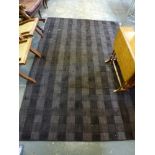 A modern Indian hand-made carpet, 'Mercubes', in shades of aubergine [floor by saleroom door] WE