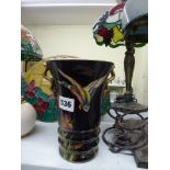 A Carlton Ware vase decorated with a duck in flight and flowers on a black ground [D] WE DO NOT