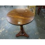 A charming 19th century circular mahogany wine table the circular figured top on a turned column and