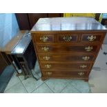 A modern yew reproduction chest of three small drawers over four long drawers and two early 20th